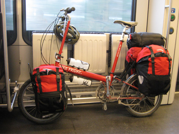 loaded Bike Friday folding bicycle on train with panniers