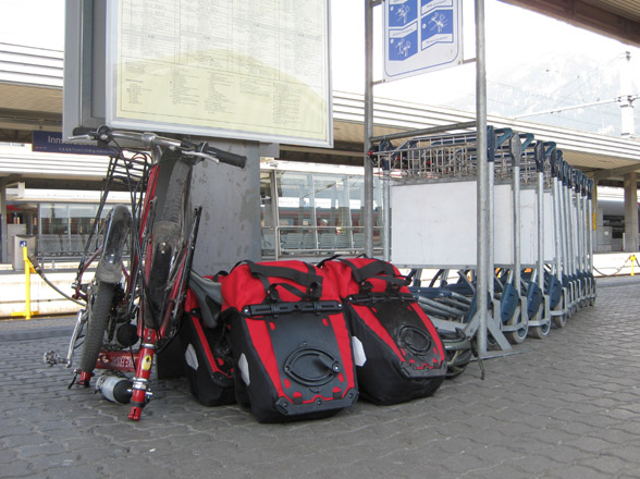 folded bike friday bicycle at train station with four panniers