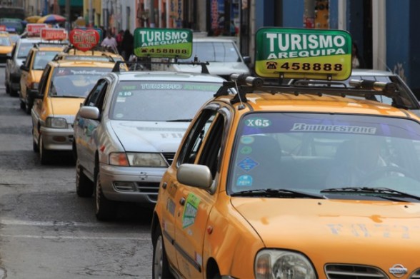a line of yellow taxi cabs in arequipa peru