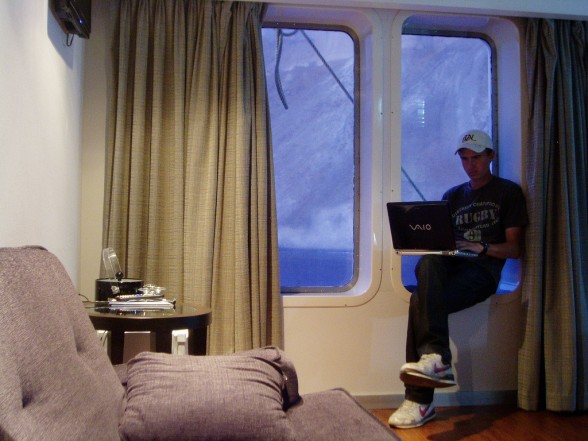 man working from his laptop on a greek cruise ship