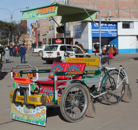 green yellow and red bicycle taxi in puno peru