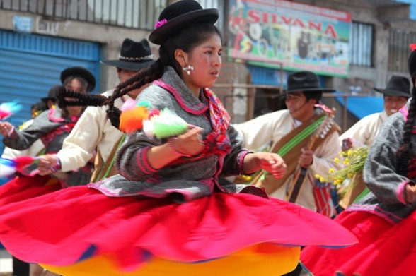 girl in red skirt dancing in a peru folk festival