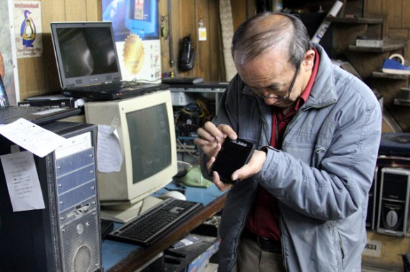 asian man repairing hard drive in huancayo peru