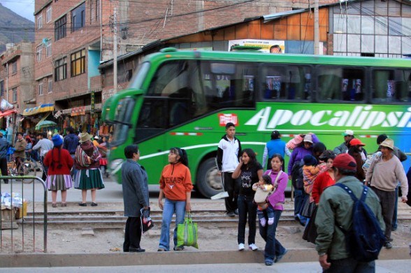 green bus passing through the city of huancayo