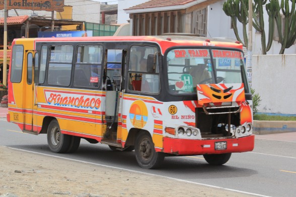 red and orange huanchaco beach city bus in trujillo peru