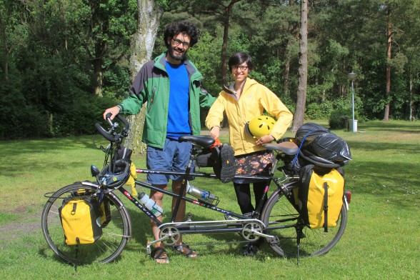 young couple on tandem bicycle tour