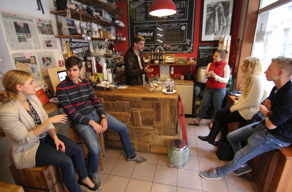 Customers gather inside the tiny Bigfoot Coffee Shop in Poznan, Poland