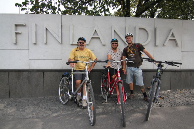 Bike Tours Helsinki - three cyclists in front of FInlandia sign