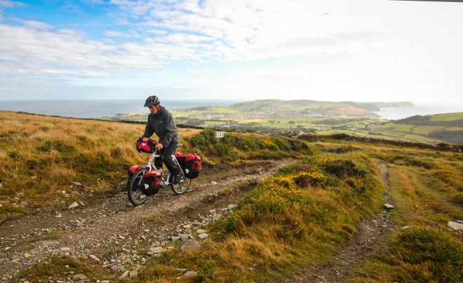 cyclist riding in mountains on the isle of man