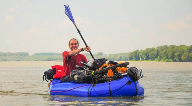 Casey Link floating down the river in his loaded packraft