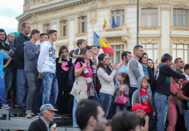 romanian flag and romani people in front of city hall building in sibiu romania