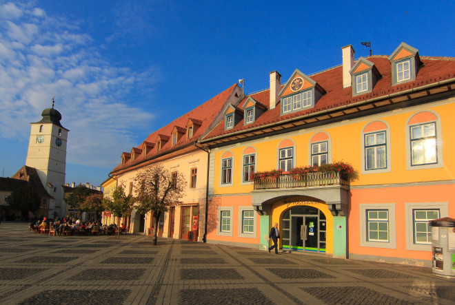 the main square in the center of sibiu romania with the clock tower in the background