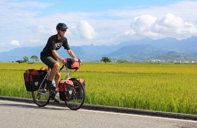 fully-loaded bicycle tourist man on road in taiwan's rift valley