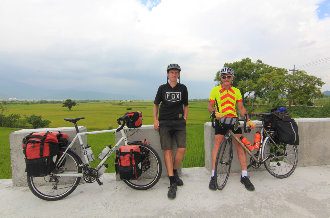 the bicycle touring pro and friend resting with their bikes in taiwan