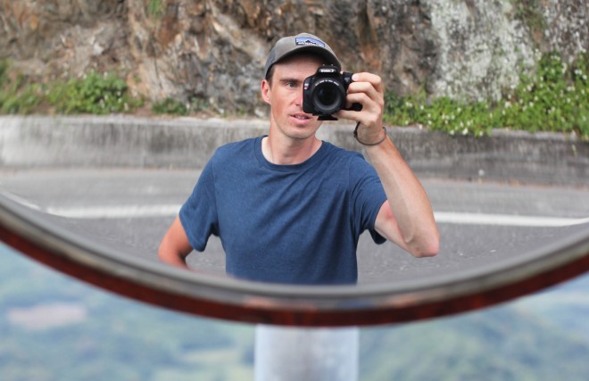 darren alff taking his photo in a curved road mirror