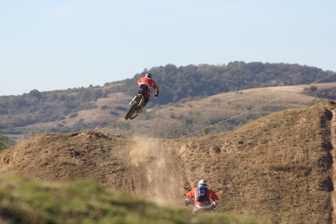 enduro motorcycle riders jumping in the air