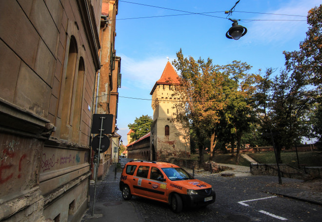 orange taxi cab and sibiu romania city wall towers