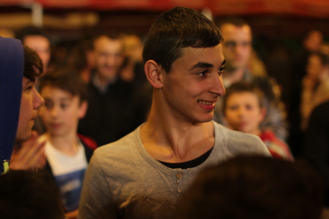young smiling romanian boy in a crowd of people