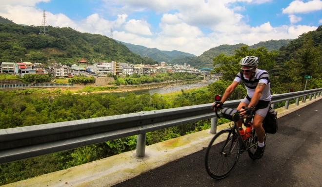 man cycles past taiwan city