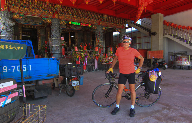 cyclist takes a rest in the shade a tao temple