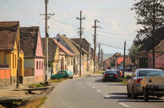 typical romanian street with houses and cars parked alongside
