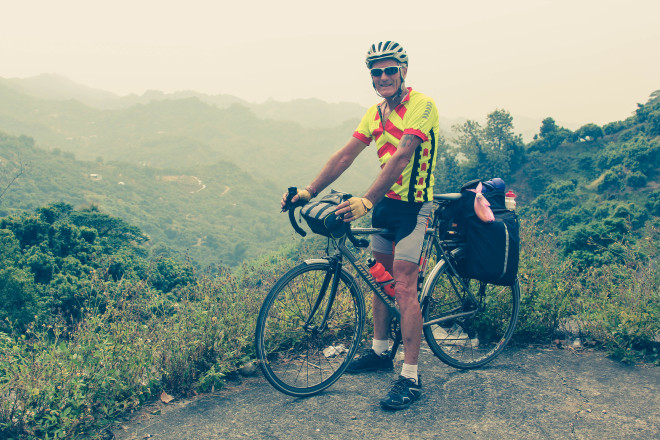 Kevin Burrett with bicycle in Taiwan mountains