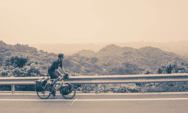 bicycle touring pro Darren Alff cycling uphill in the mountains of Taiwan