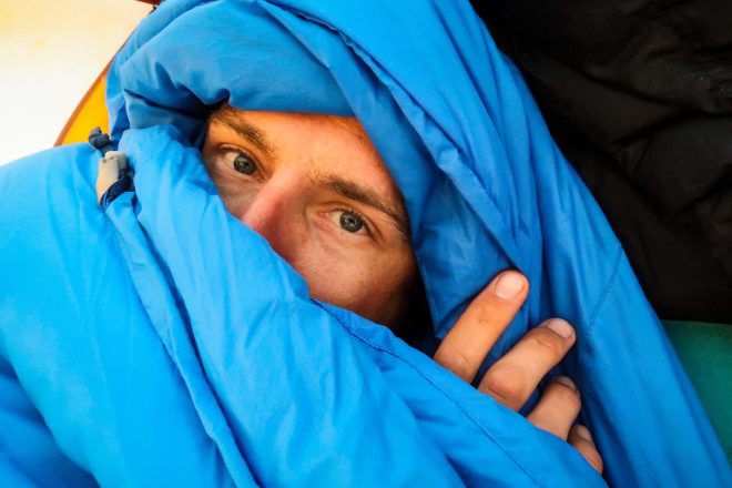 Peeking out of sleeping bag during bike tour