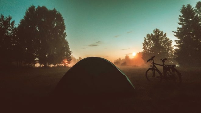 tent and bicycle looking into Swedish sunset