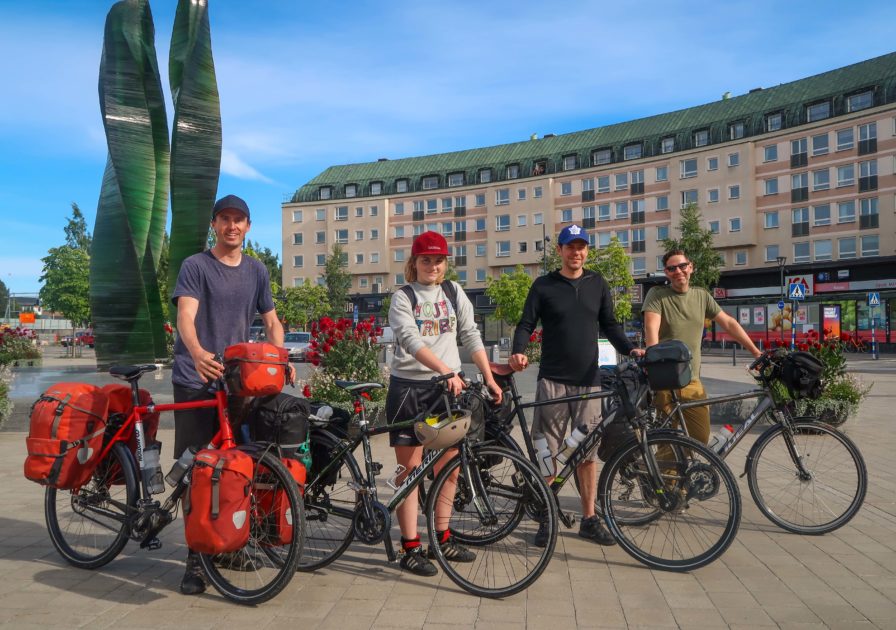 Darren Alff, Line Gammelli, Doug Ireland and Roberto LoRusso with their loaded touring bicycles in the center of Umea, Sweden