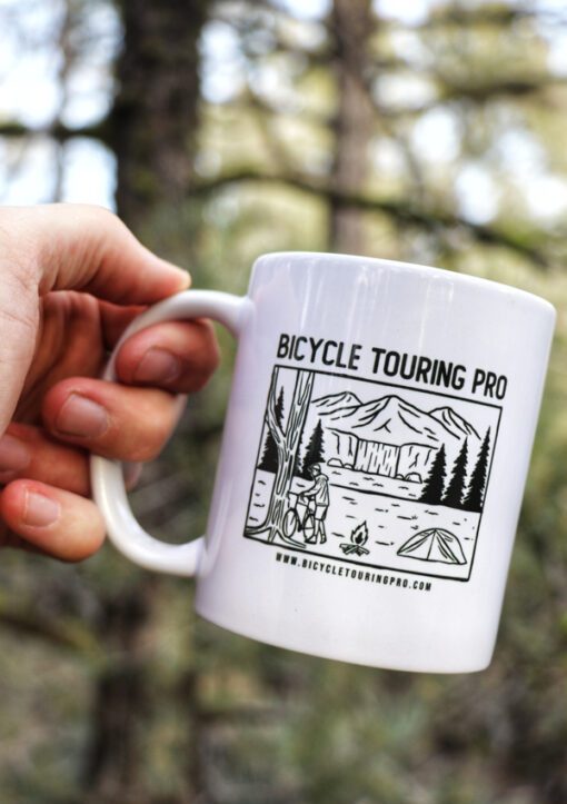 Holding the Bicycle Touring Pro "Wild Camping" Coffee Cup in my hand